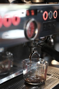 Close-up of coffee cup under espresso machine