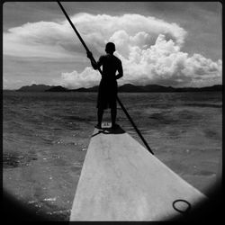 Silhouette of man standing against cloudy sky