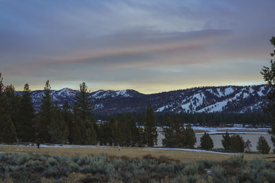 Scenic view of snowcapped mountains against sky during sunset