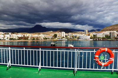 Boat on sea against cloudy sky