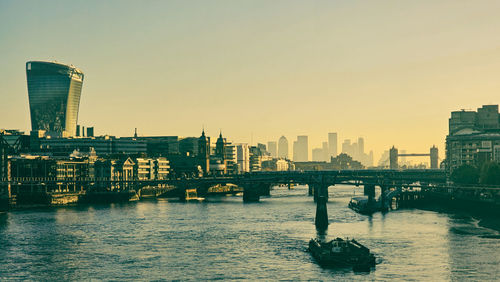 Bridge over river against sky during sunset