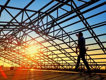 Low angle view of man standing against sky