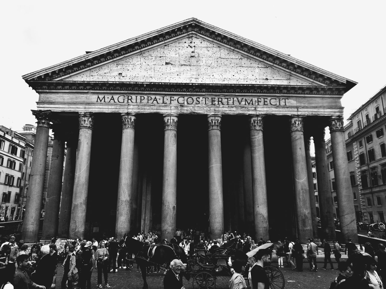 GROUP OF PEOPLE IN FRONT OF TRADITIONAL BUILDING