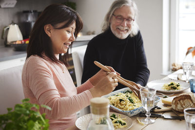 Man and woman eating dinner at home together