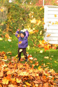 Girl standing on field during autumn