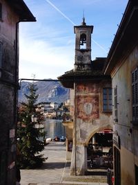 Street amidst buildings in town against sky