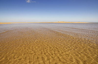 Scenic view of beach against sky