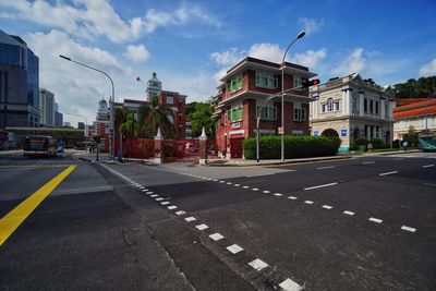 Road by city against sky