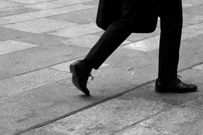 Low section of man skateboarding on floor