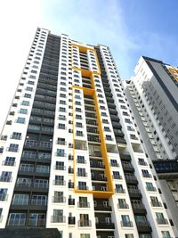 Low angle view of modern buildings in city against sky