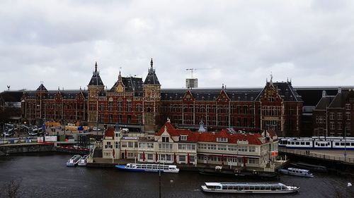 Boats in river with buildings in background