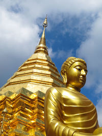 Statue of buddha against building