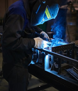 Man working on metal structure in factory