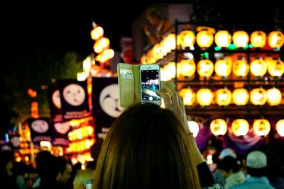 Woman photographing with mobile phone