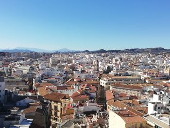 High angle shot of townscape against blue sky