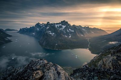 Scenic view of mountains and lake against sky during sunset