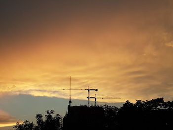 Low angle view of silhouette trees against sky during sunset