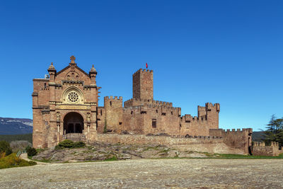 Old ruins of building against blue sky