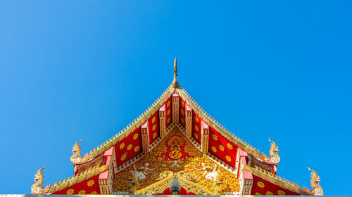 Low angle view of temple against blue sky