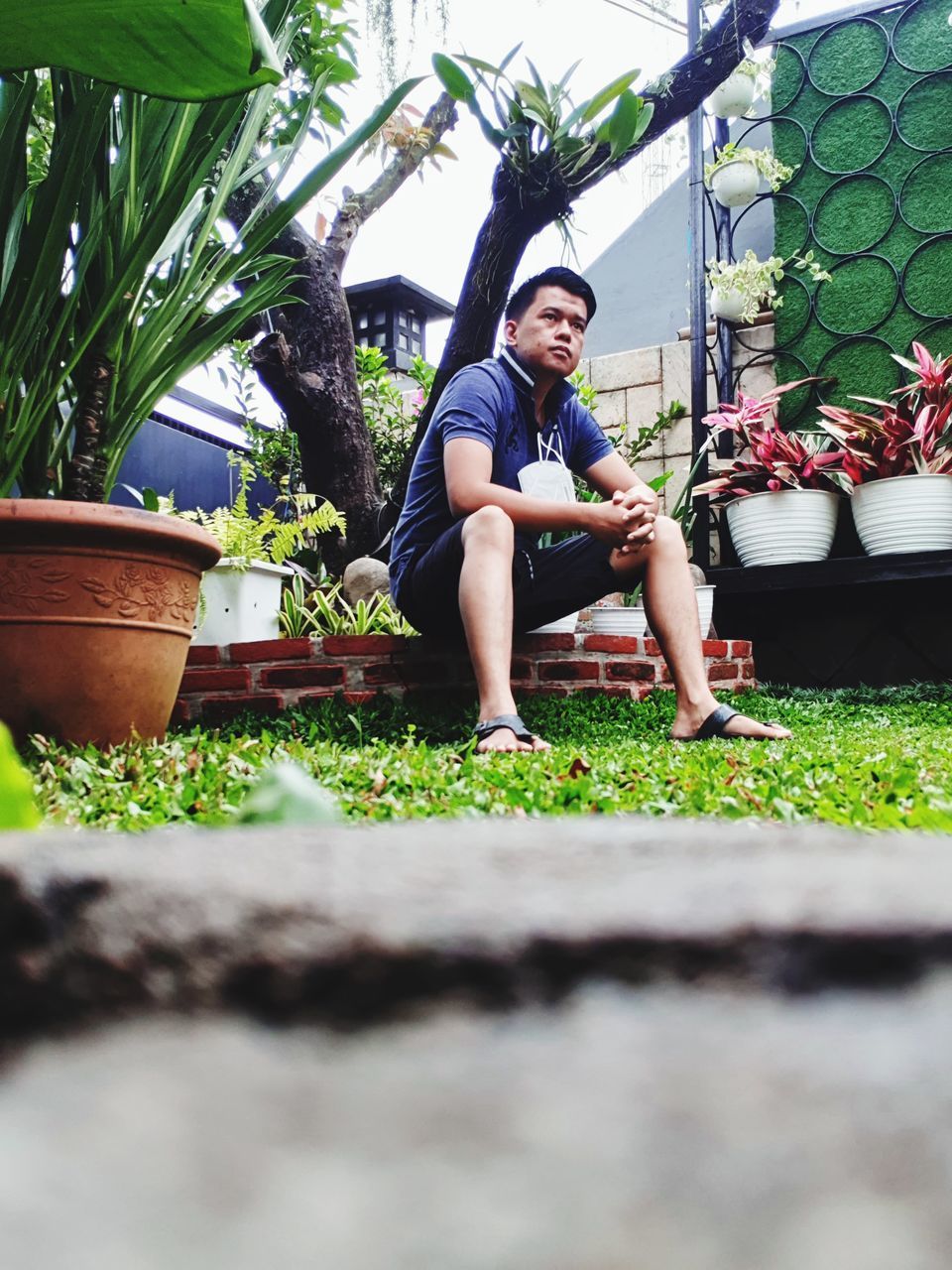 FULL LENGTH PORTRAIT OF MATURE MAN SITTING IN POT