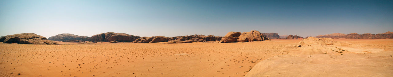 Panoramic view of desert against clear sky