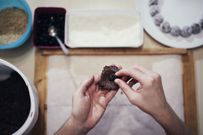 High angle view of hand holding ice cream on table