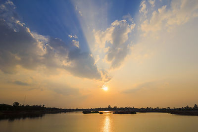 Scenic view of lake against sky during sunset