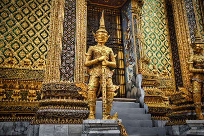 Statue of temple against building