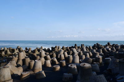 Stack of rocks on beach against sky