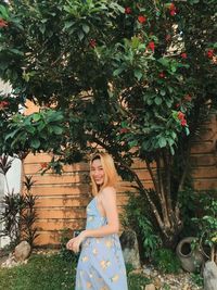 Portrait of woman standing against plants