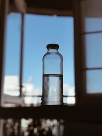 Close-up of bottle on window