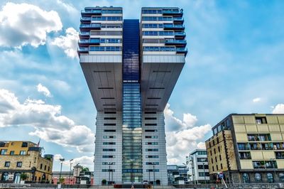 Low angle view of building against cloudy sky