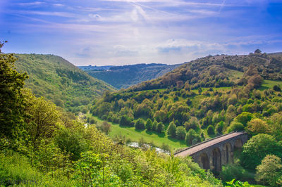 Scenic view of mountains against blue sky during sunny day