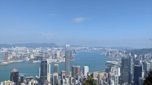 High angle view of city by sea against sky