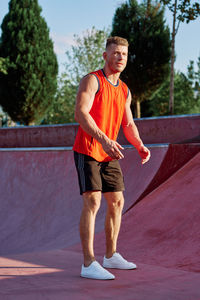 Portrait of young man exercising on road