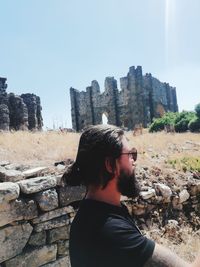 Portrait of man against built structure against sky