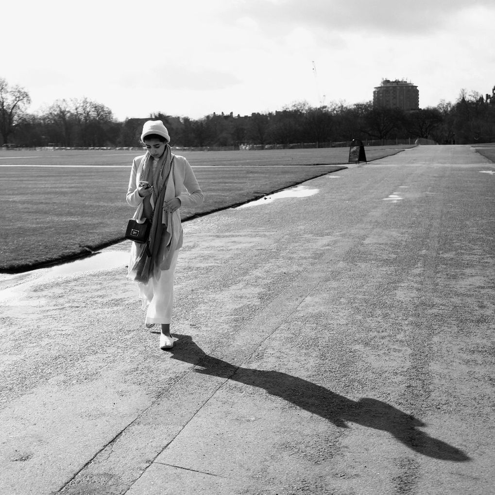 full length, real people, one person, leisure activity, lifestyles, shadow, outdoors, walking, sunlight, day, sky, nature, young adult, young women, tree, people