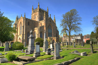 View of cemetery and buildings against sky