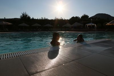 Sun shining over swimming pool