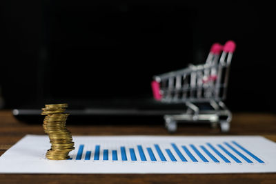 Close-up of coins on table against black background