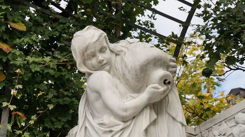 Low angle view of statue against trees