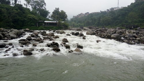 Scenic view of river flowing through rocks