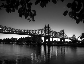 Low angle view of silhouette queensboro bridge over river at night