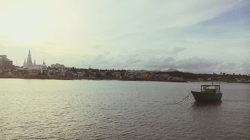 Boats in river with buildings in background