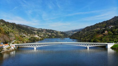 Arch bridge over river against sky