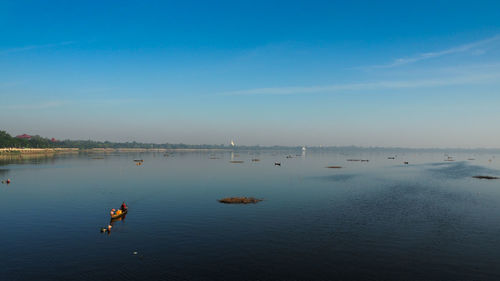 Scenic view of river against blue sky