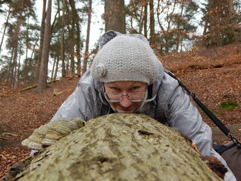 Portrait of woman hugging tree trunk