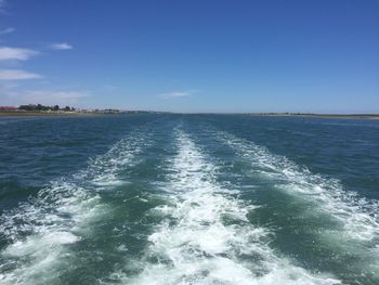 Scenic view of sea against blue sky