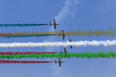 Low angle view of airshow against sky