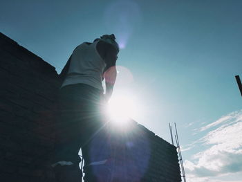 Low angle view of building against bright sun